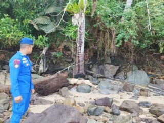 Petugas Ditpolairud Polda Sumbar bersama tim SAR mengevakuasi mayat pria tak dikenal yang ditemukan nelayan di Pantai Bukit Lampu Padang
